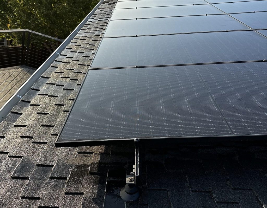 Solar installer working on rooftop panels in Saratoga, CA